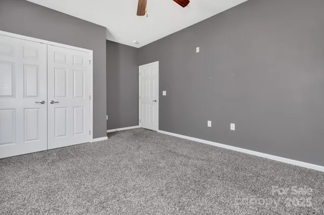 an empty room with windows and closet