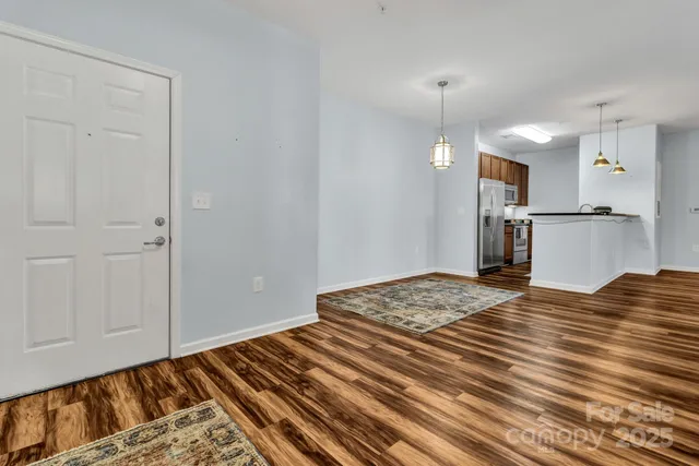 en empty room with wooden floor and ceiling fan