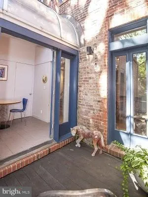 a couple of potted plants in front of door