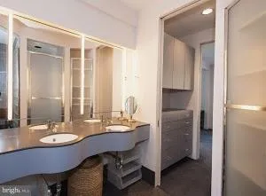 a bathroom with a granite countertop sink a mirror and a bathtub