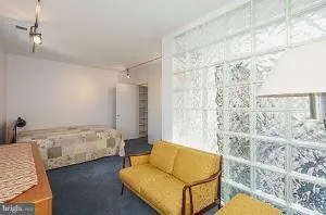 a bedroom with a bed and couch