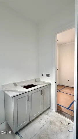 a utility room with cabinets washer and dryer