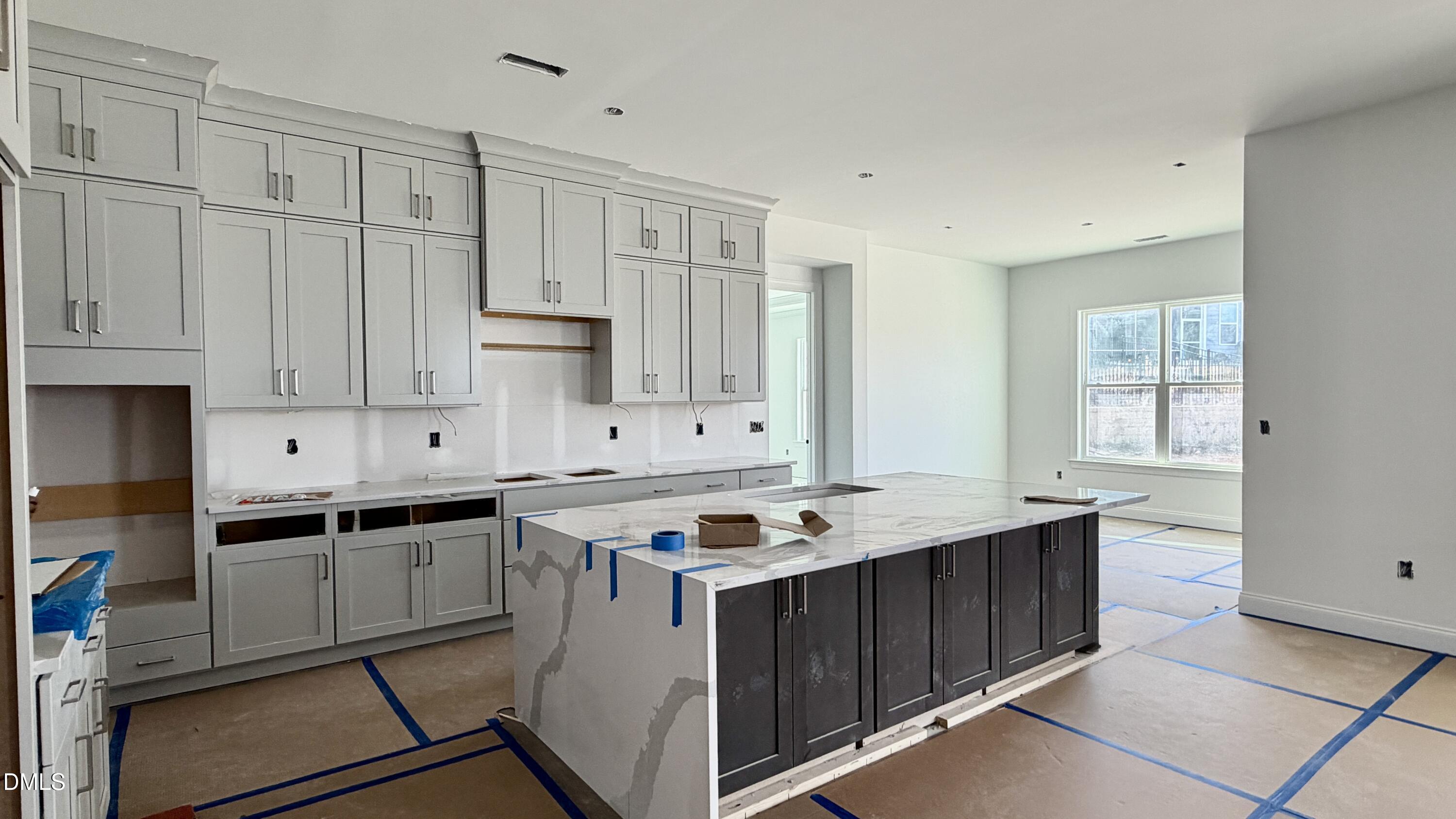 2232 Abbeyhill Drive, Unit 107 Raleigh, NC 27610 - Photo 3 of 26 a kitchen with stainless steel appliances granite countertop a stove a sink and a refrigerator