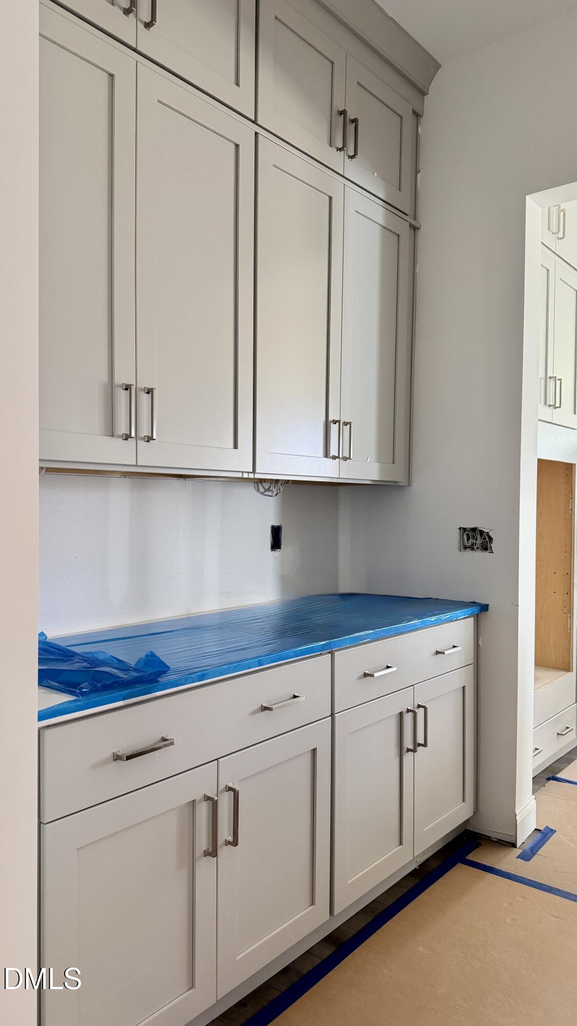 2232 Abbeyhill Drive, Unit 107 Raleigh, NC 27610 - Photo 4 of 26 a kitchen with white cabinets and white appliances