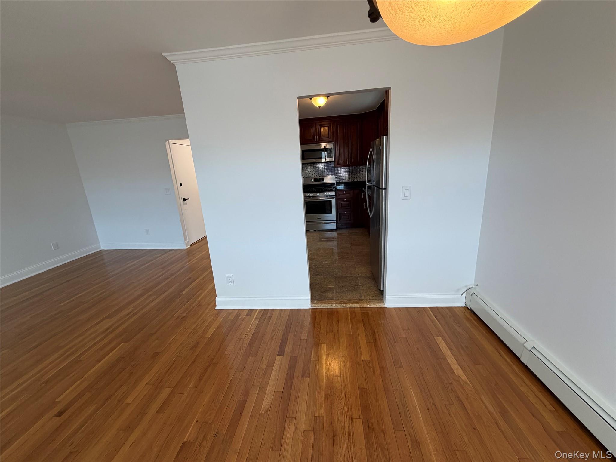 144-50 25th Road Queens, NY 11354 - Photo 12 of 20 wooden floor in an empty room