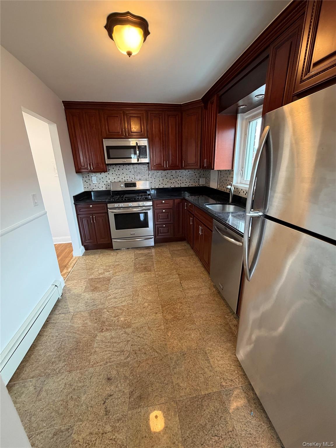 144-50 25th Road Queens, NY 11354 - Photo 6 of 20 a kitchen with stainless steel appliances granite countertop a refrigerator and a stove