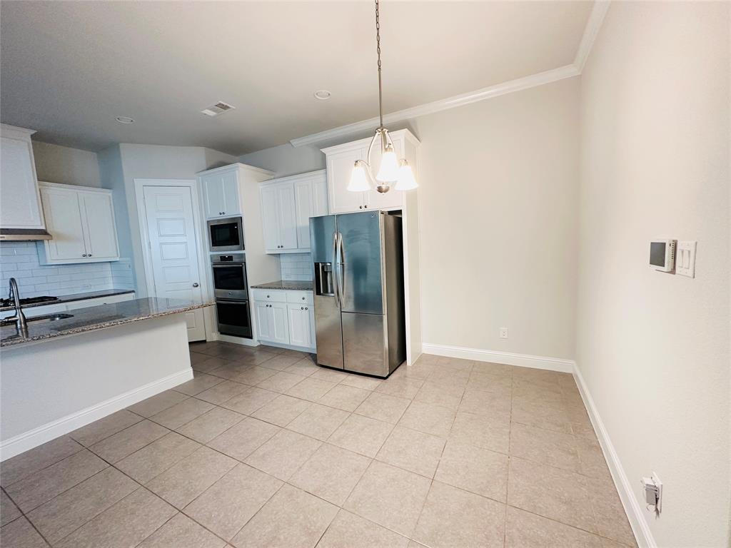 806 Davids Way Allen, TX 75013 - Photo 8 of 24 a kitchen with stainless steel appliances a refrigerator and cabinets