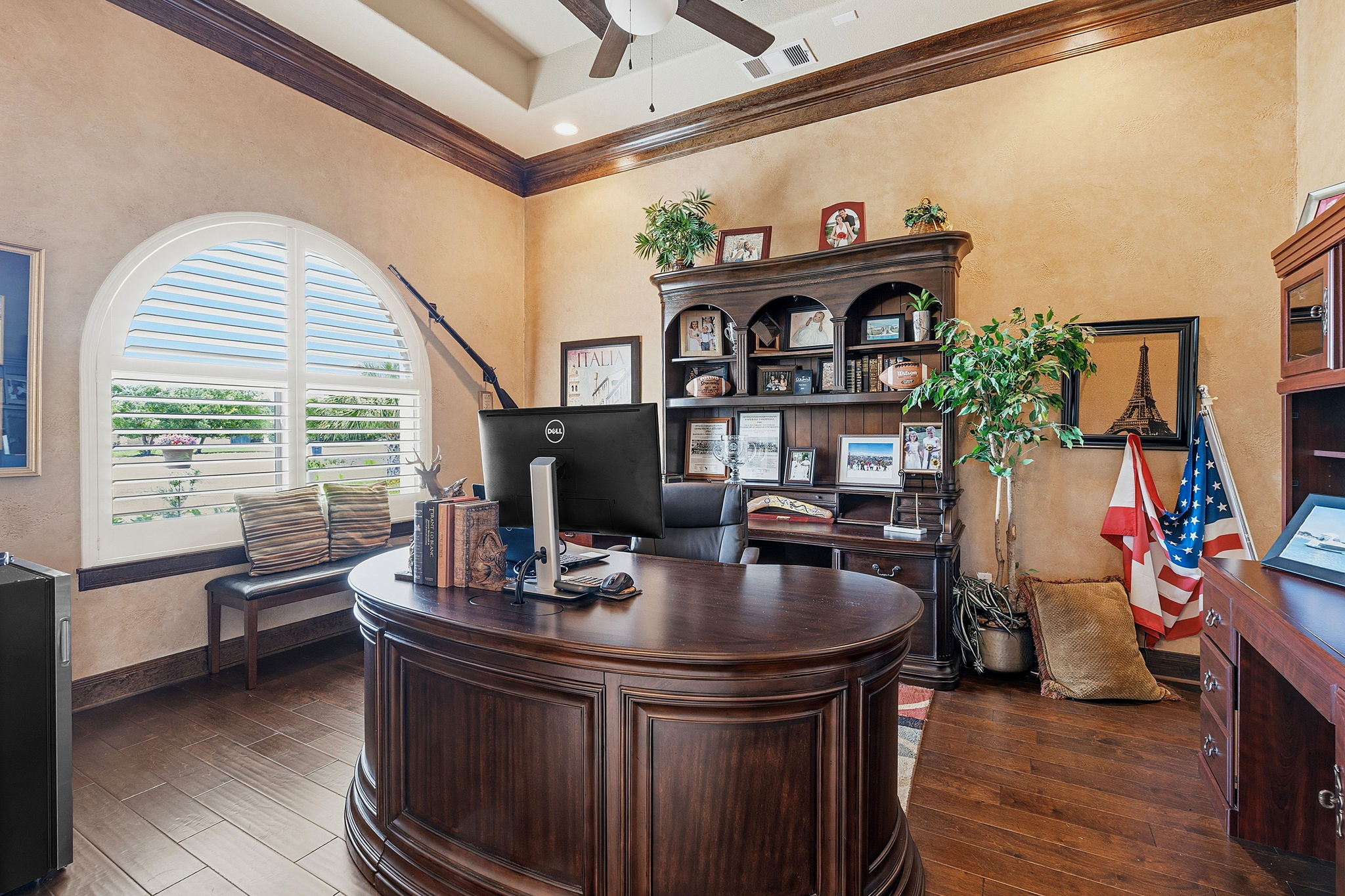 816 Brave Face Street Leander, TX 78641 - Photo 12 of 40 Rich hardwood floors complement the warm walls in this home office, offering a productive and inviting atmosphere.
