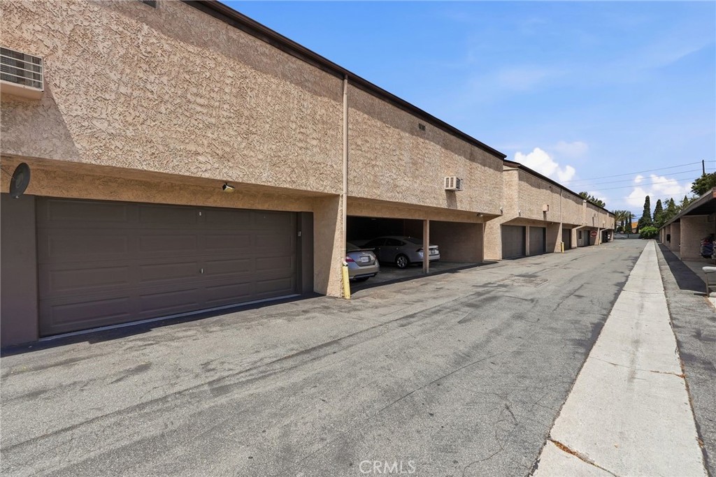 7890 East Spring Street, Unit 2L Long Beach, CA 90815 - Photo 34 of 47 a front view of a house with a road