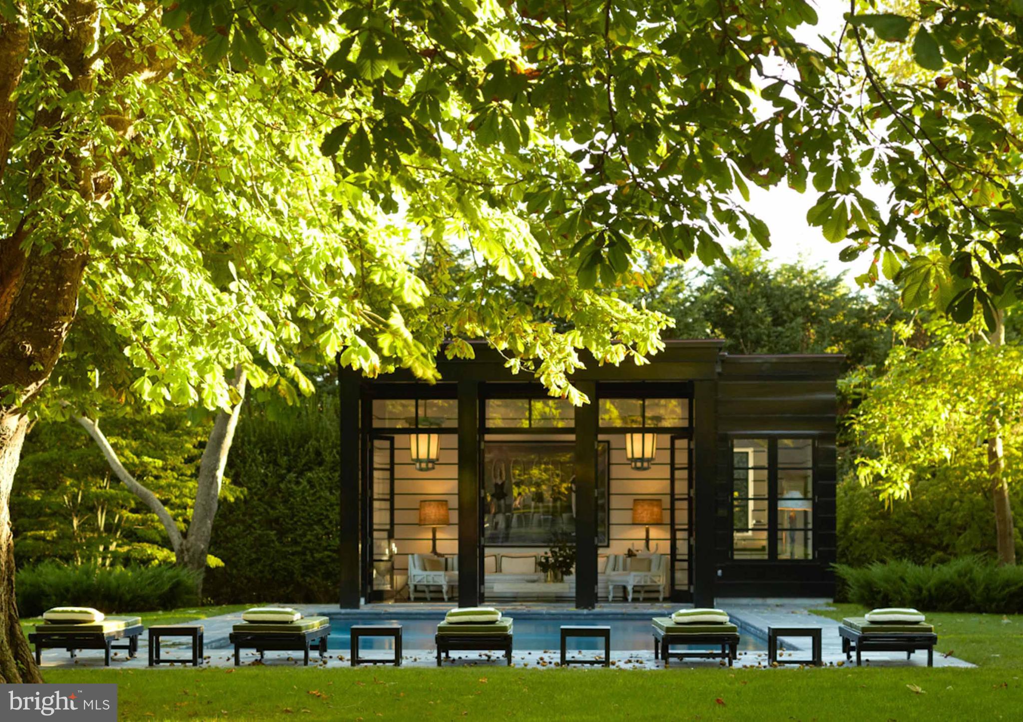 933 Hillside Road Lutherville-Timonium, MD 21093 - Photo 13 of 57 front view of a brick house with a large windows and large trees