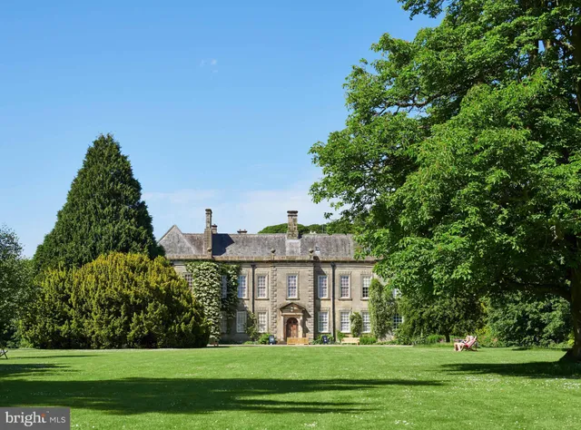 a living room with furniture and a lamp