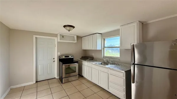 a kitchen with a refrigerator sink and stove