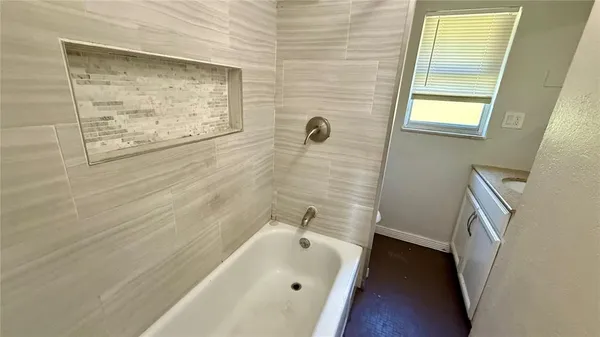 a bathroom with a tub and sink