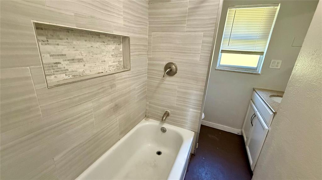 1314 North Combee Road, Unit 4 Lakeland, FL 33801 - Photo 6 of 12 a bathroom with a tub and sink