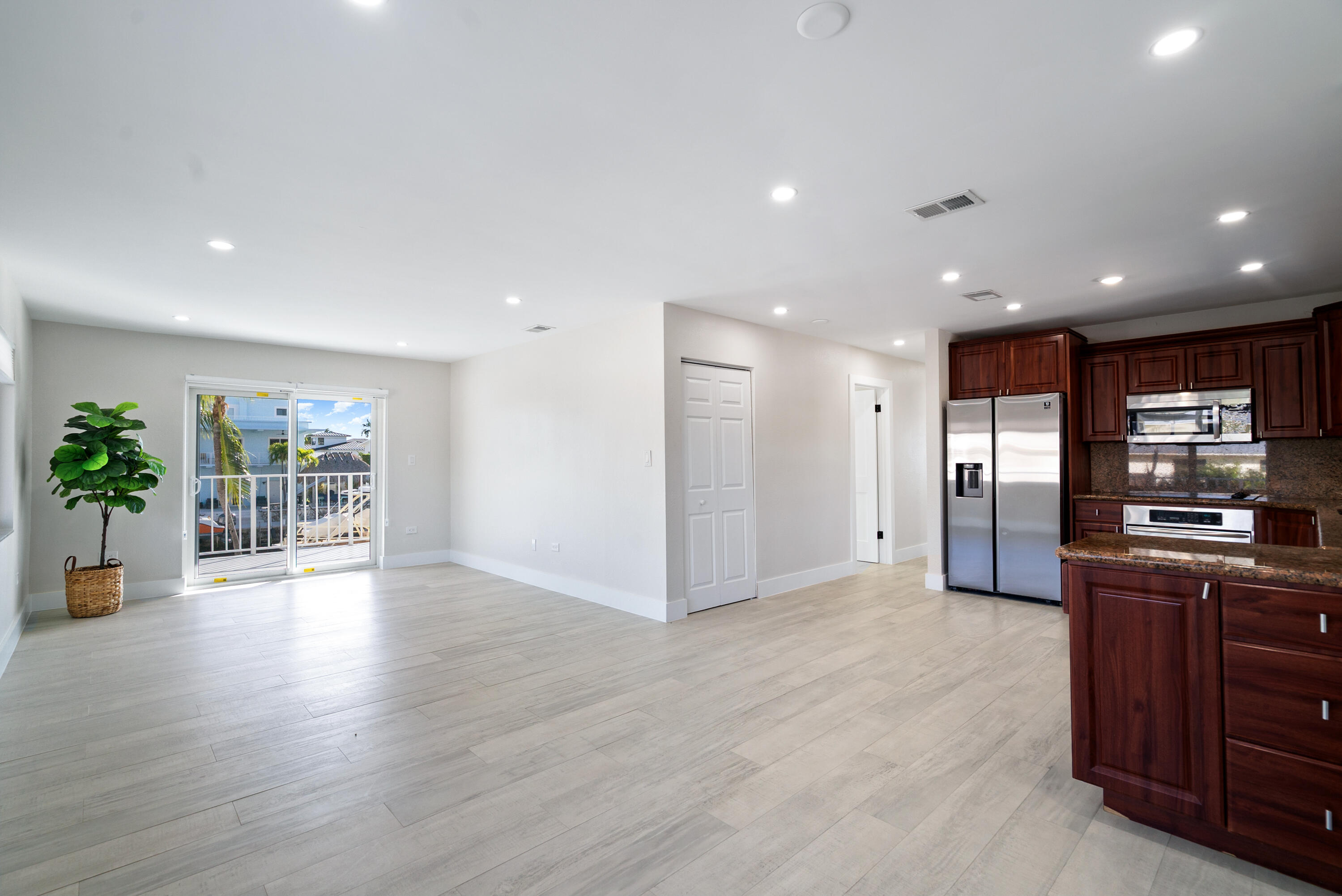 392 Laguna Avenue Key Largo, FL 33037 - Photo 12 of 42 a view of kitchen with stainless steel appliances kitchen island wooden floor and living room
