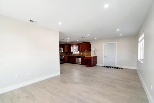 a view of kitchen with refrigerator and window