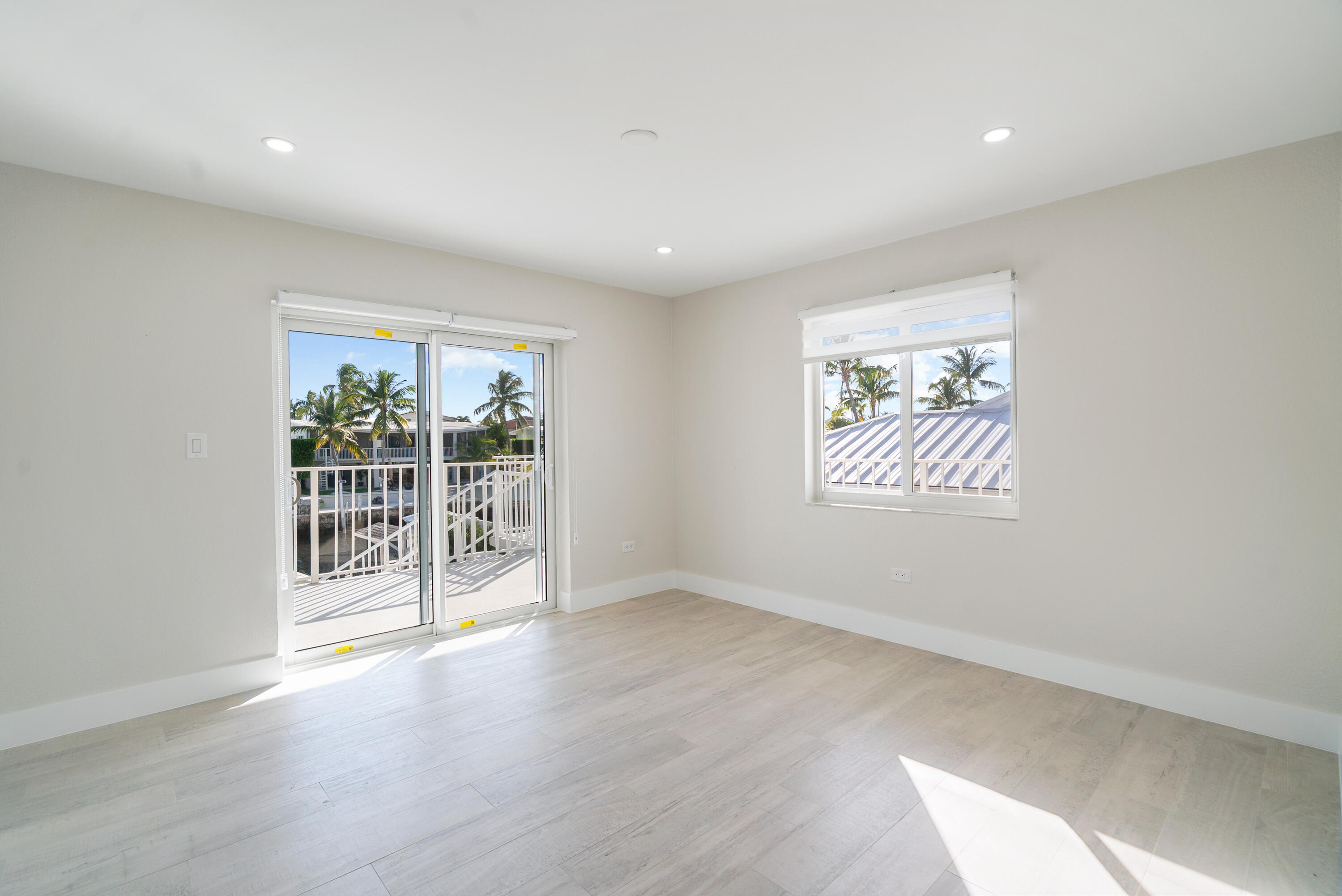 392 Laguna Avenue Key Largo, FL 33037 - Photo 26 of 42 an empty room with wooden floor and windows