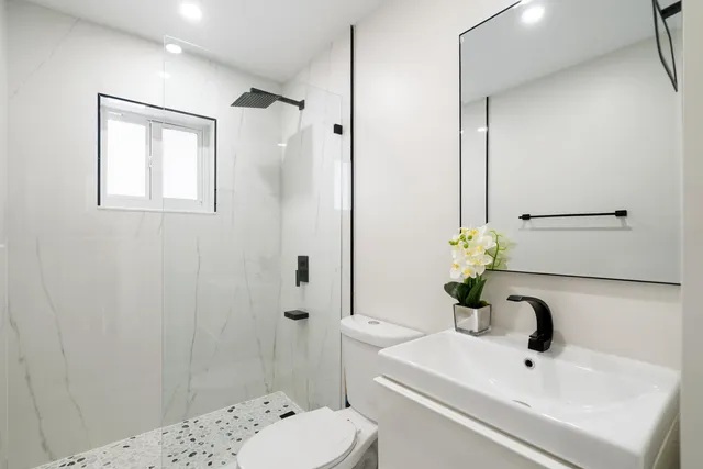 a bathroom with a sink toilet and shower