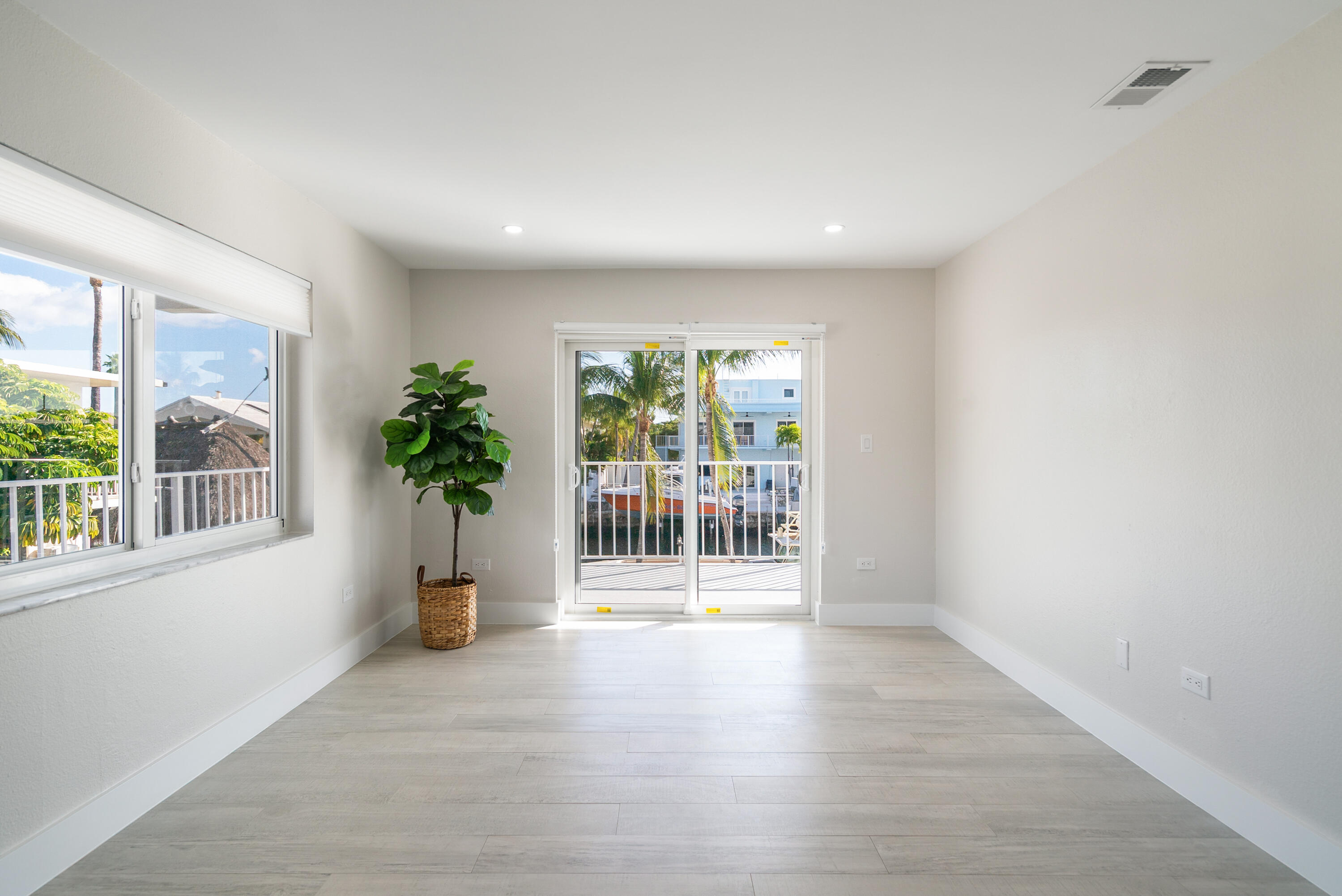 392 Laguna Avenue Key Largo, FL 33037 - Photo 32 of 42 wooden floor in an empty room with a window