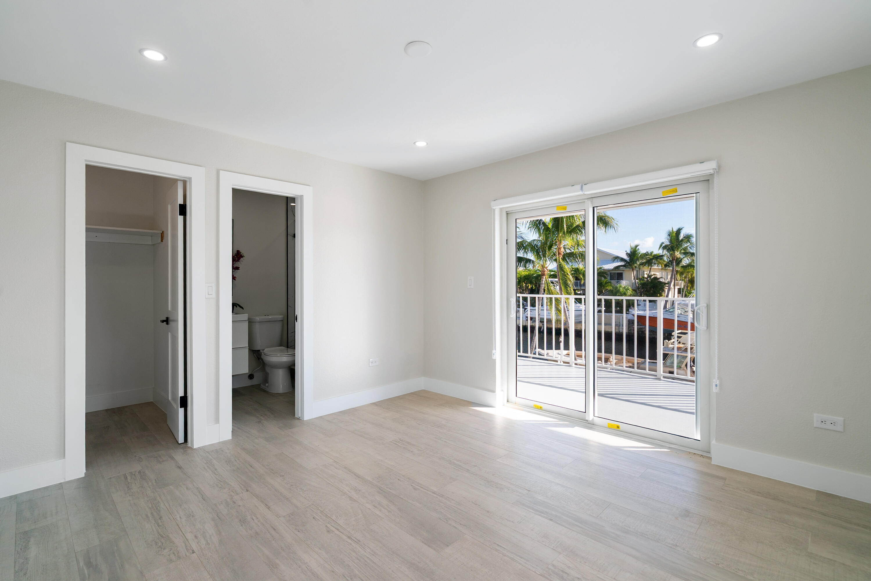 392 Laguna Avenue Key Largo, FL 33037 - Photo 34 of 42 an empty room with wooden floor and a window