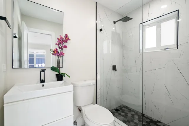a bathroom with a sink toilet and shower