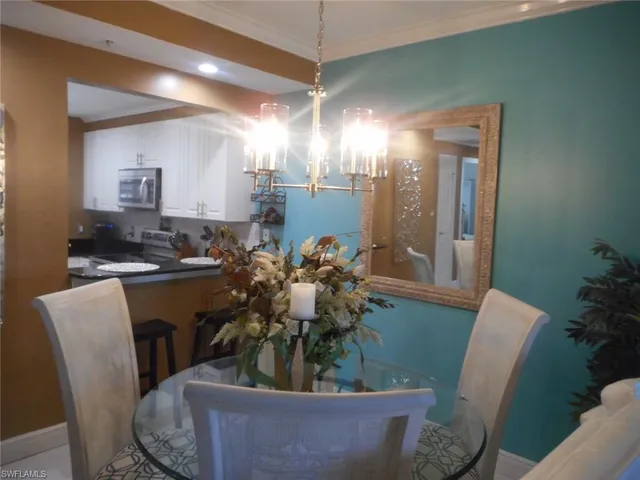 a view of a dining room with furniture and a chandelier