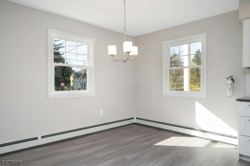 80 East Main Street, Unit 5 Mendham, NJ 07945 - Photo 11 of 28 an empty room with wooden floor and windows