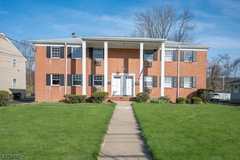 80 East Main Street, Unit 5 Mendham, NJ 07945 - Photo 2 of 28 a front view of a house with a yard
