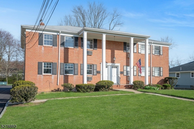 80 East Main Street, Unit 5 Mendham, NJ 07945 - Photo 28 of 28 a front view of a house with a yard