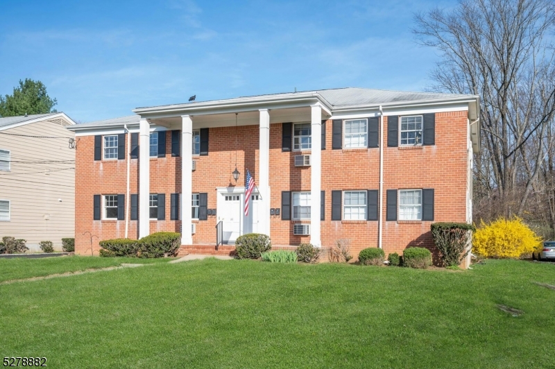 80 East Main Street, Unit 5 Mendham, NJ 07945 - Photo 3 of 28 a front view of a house with garden