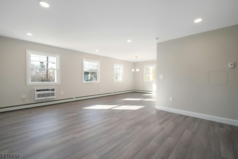 80 East Main Street, Unit 5 Mendham, NJ 07945 - Photo 7 of 28 an empty room with wooden floor and windows