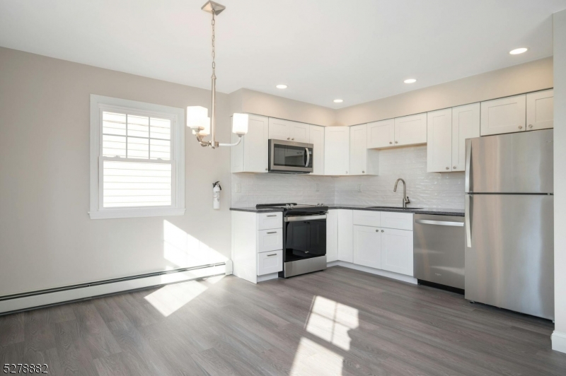 80 East Main Street, Unit 5 Mendham, NJ 07945 - Photo 9 of 28 a kitchen with granite countertop stainless steel appliances a refrigerator sink and microwave