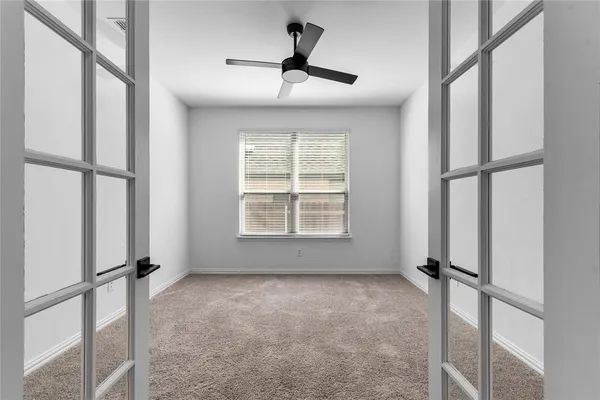 a view of room with a ceiling fan