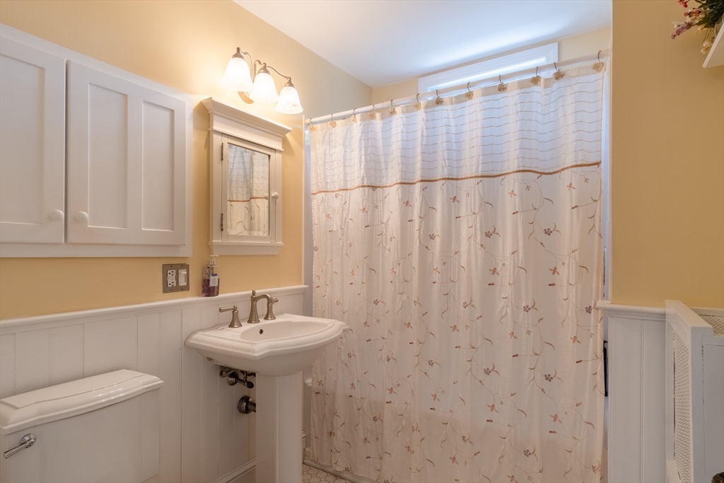 160 Abbott Street Springfield, MA 01118 - Photo 19 of 34 a bathroom with a sink a toilet and a mirror