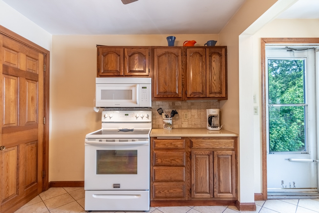 160 Abbott Street Springfield, MA 01118 - Photo 10 of 34 a kitchen with granite countertop a stove a sink and a microwave