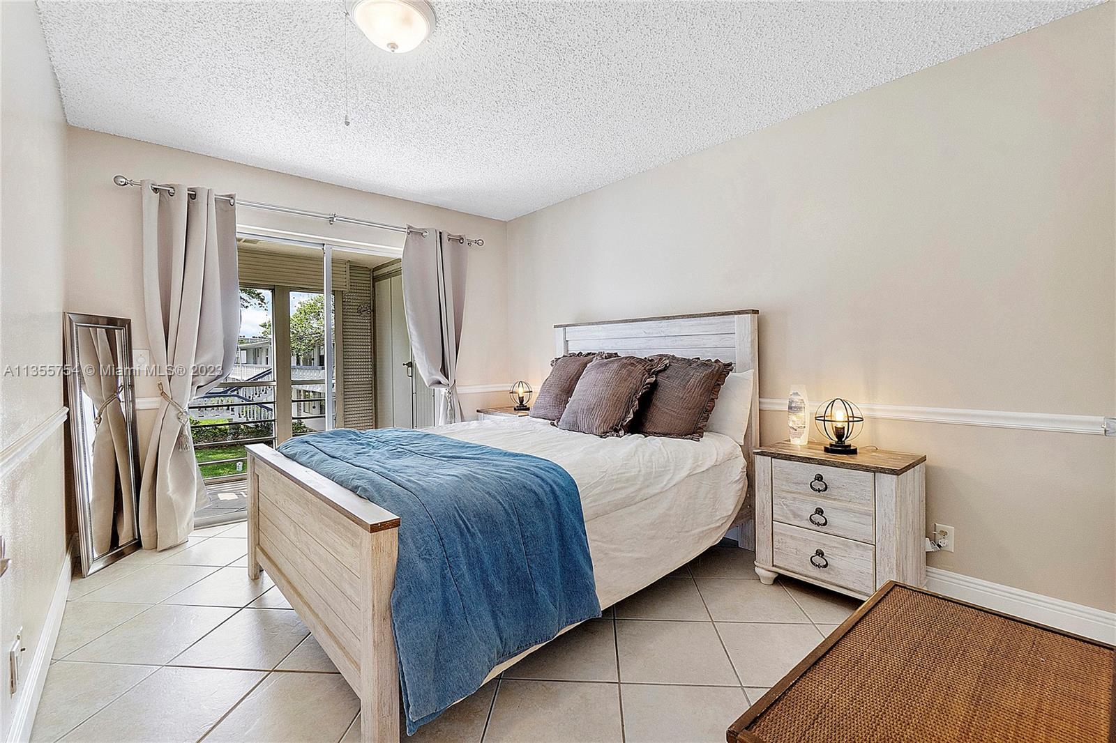 357 Durham, Unit 357 Deerfield Beach, FL 33442 - Photo 11 of 41 a bedroom with a bed and a dresser