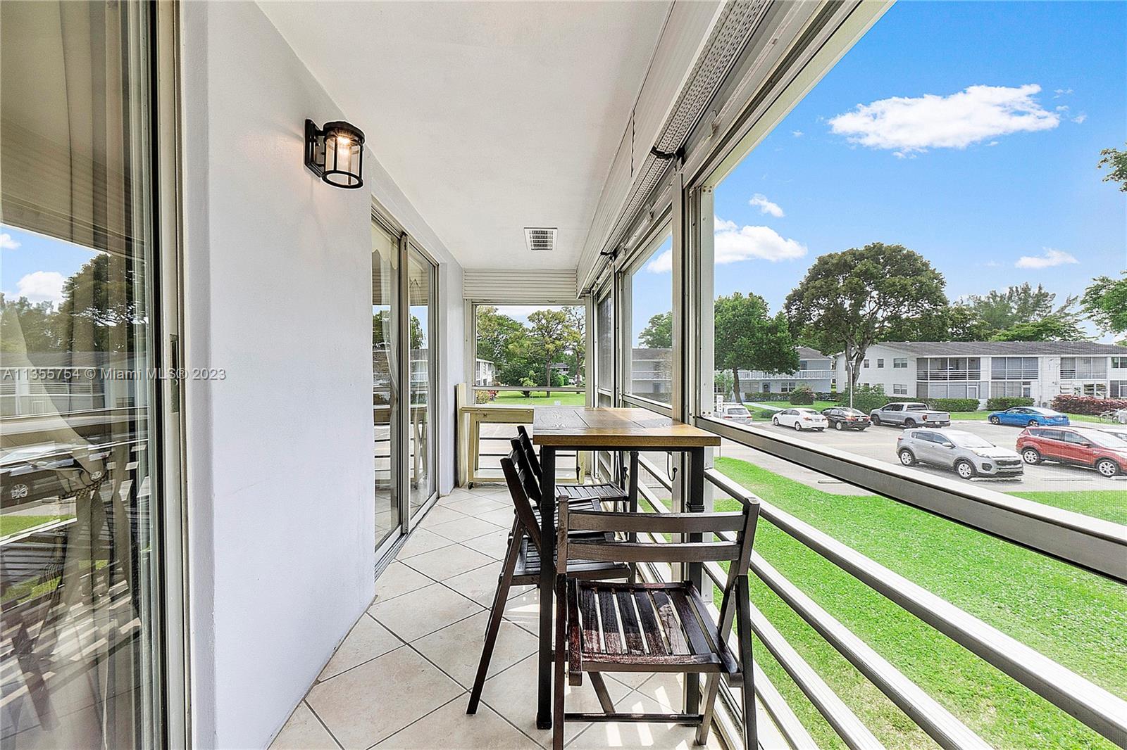 357 Durham, Unit 357 Deerfield Beach, FL 33442 - Photo 12 of 41 a view of a chairs and table in a balcony