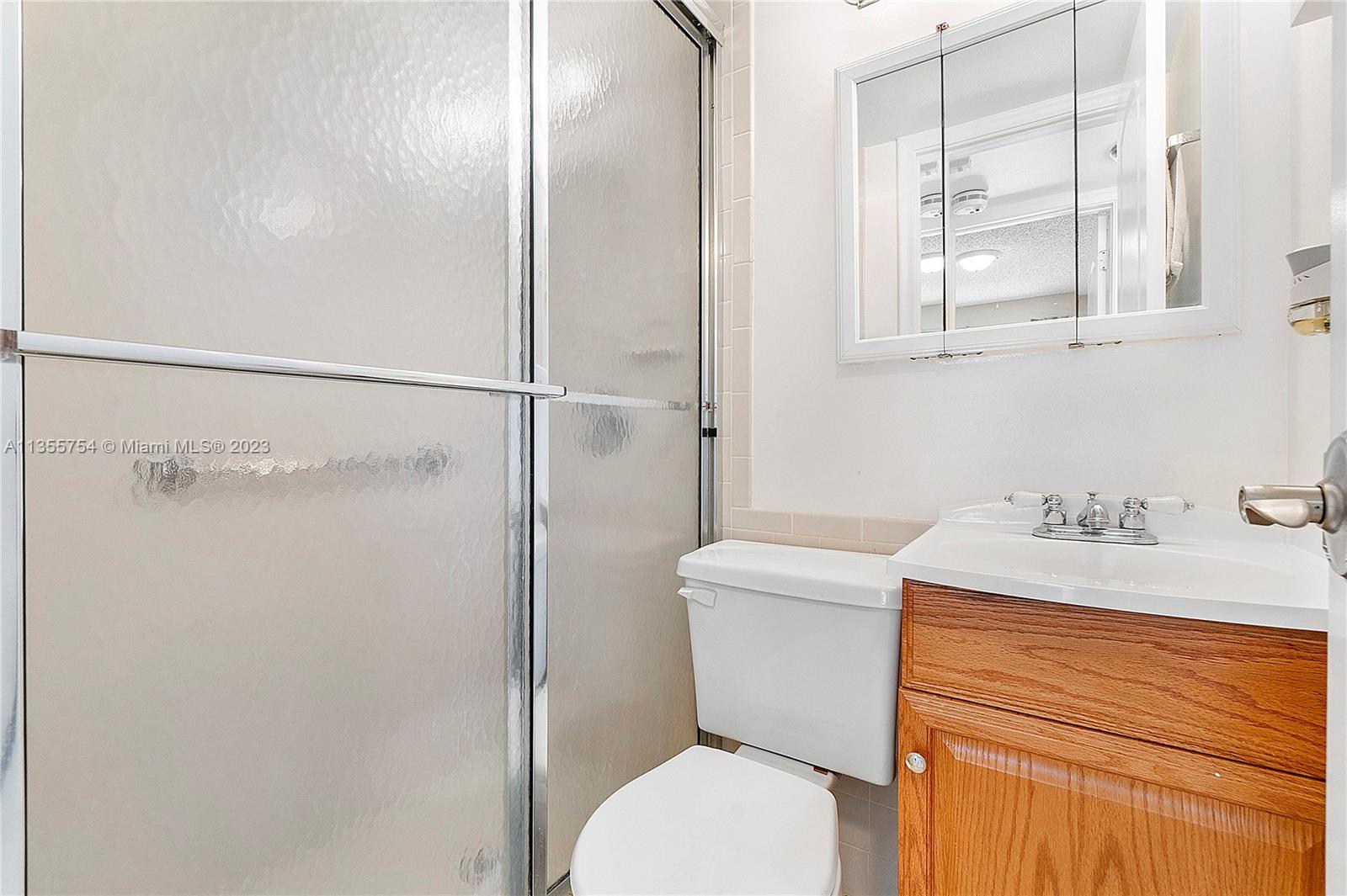 357 Durham, Unit 357 Deerfield Beach, FL 33442 - Photo 13 of 41 a bathroom with a granite countertop sink toilet and shower