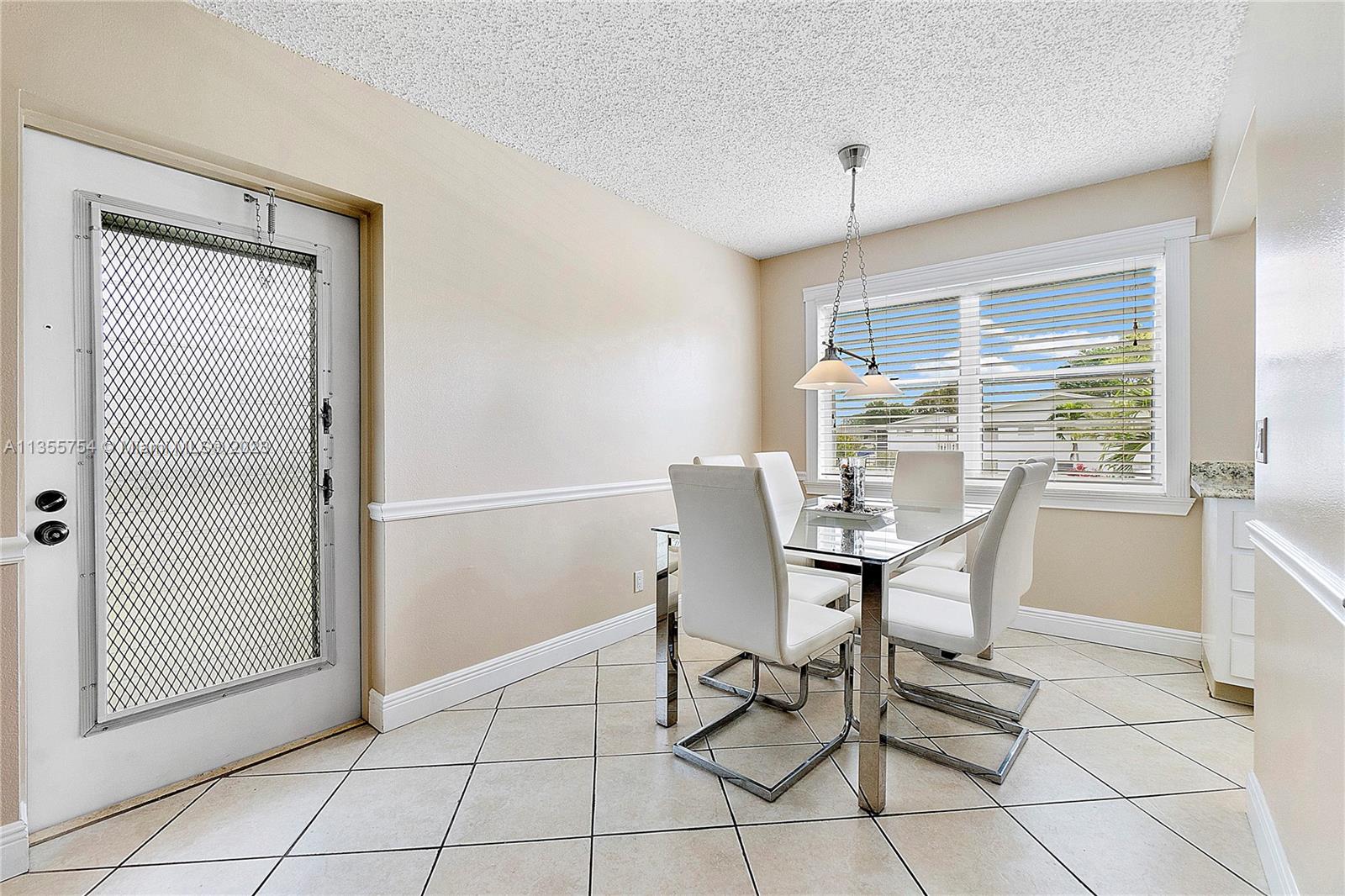 357 Durham, Unit 357 Deerfield Beach, FL 33442 - Photo 15 of 41 a dining room with furniture and window