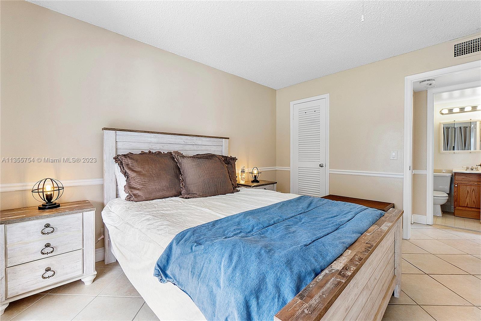 357 Durham, Unit 357 Deerfield Beach, FL 33442 - Photo 18 of 41 a bedroom with a bed and a dresser