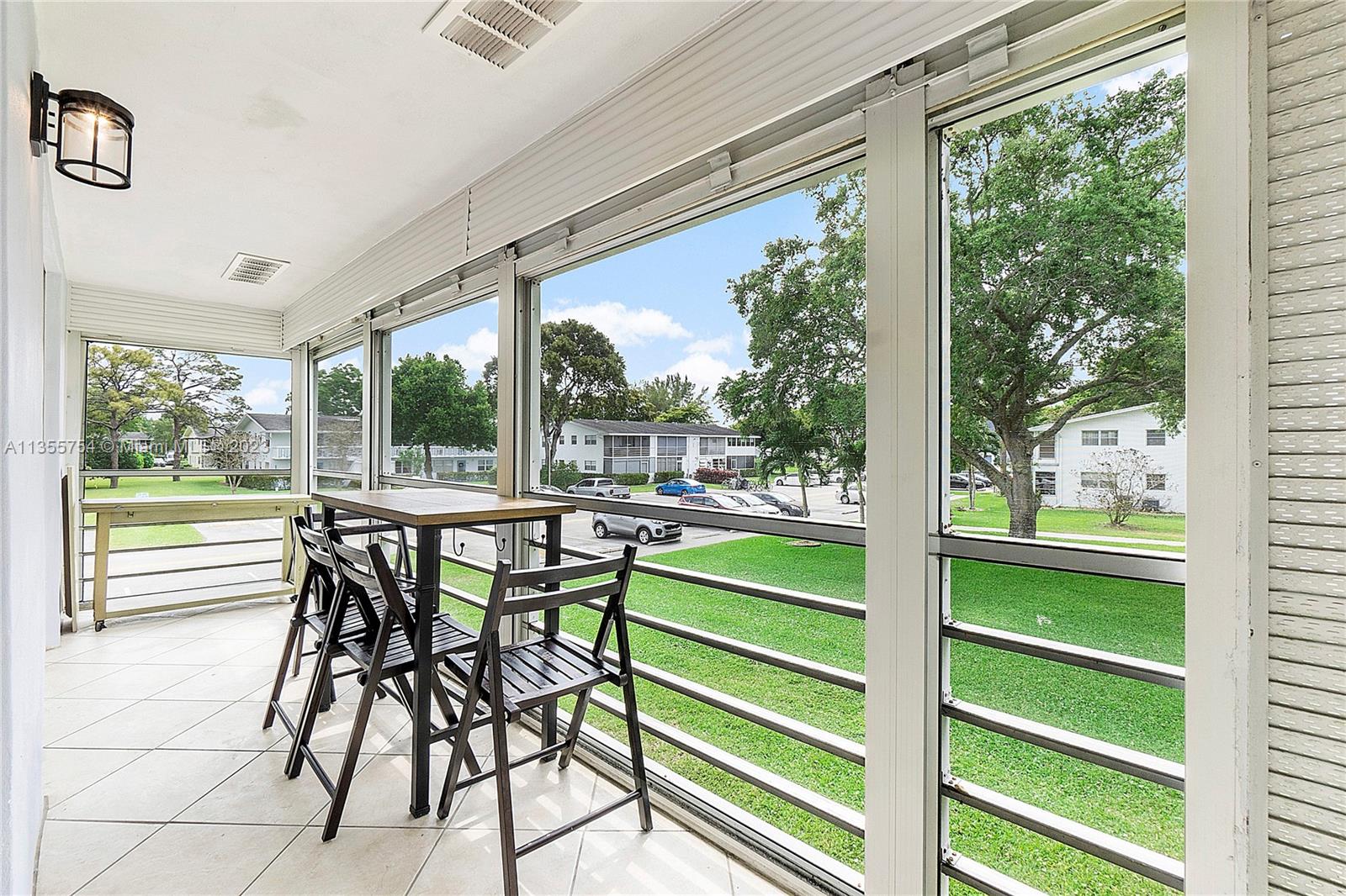 357 Durham, Unit 357 Deerfield Beach, FL 33442 - Photo 19 of 41 a dining room with furniture and a garden view