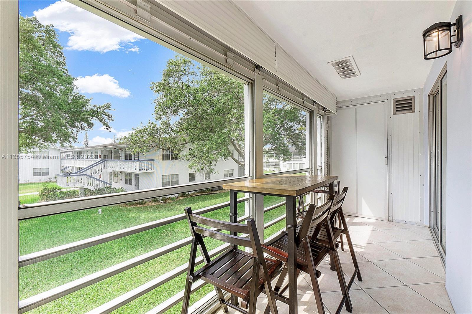 357 Durham, Unit 357 Deerfield Beach, FL 33442 - Photo 2 of 41 a view of a dining room with furniture window and outside view