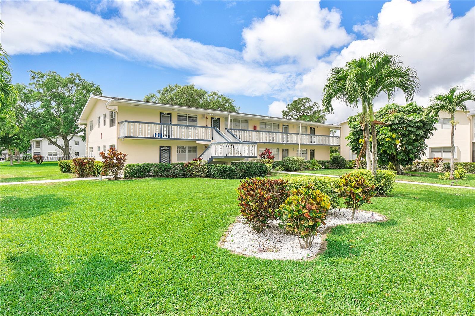 357 Durham, Unit 357 Deerfield Beach, FL 33442 - Photo 29 of 41 a front view of a house with a yard