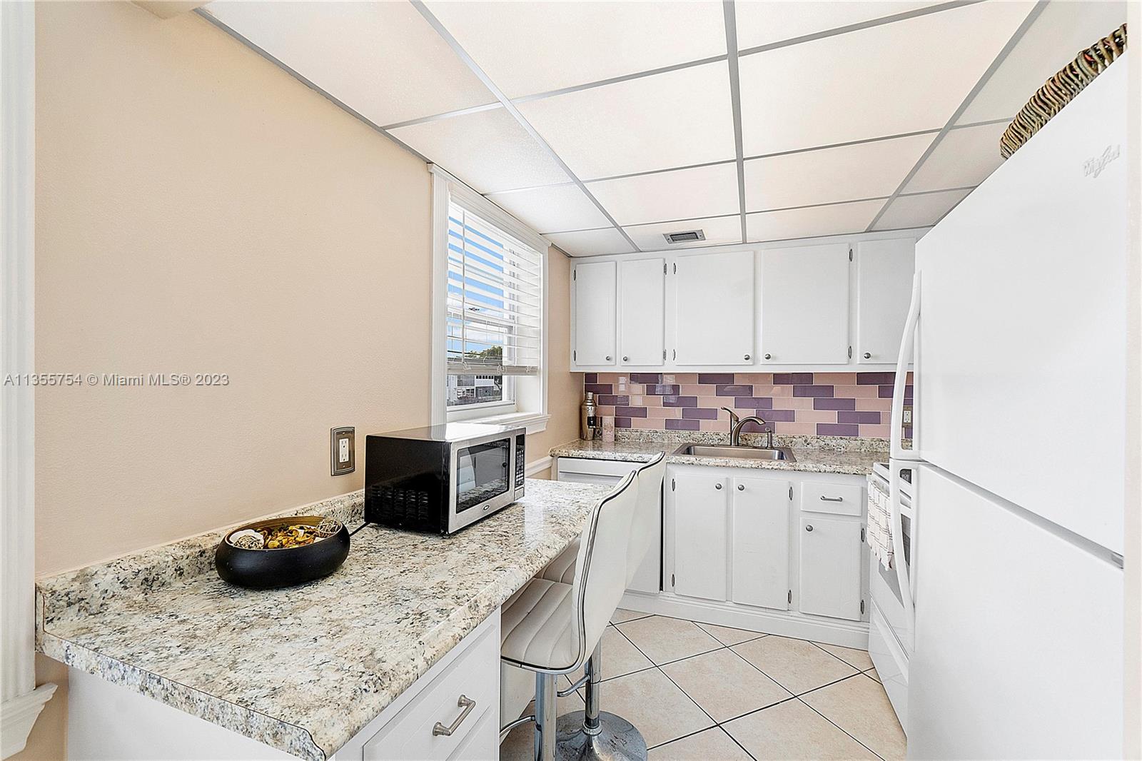 357 Durham, Unit 357 Deerfield Beach, FL 33442 - Photo 4 of 41 a kitchen with a sink and cabinets