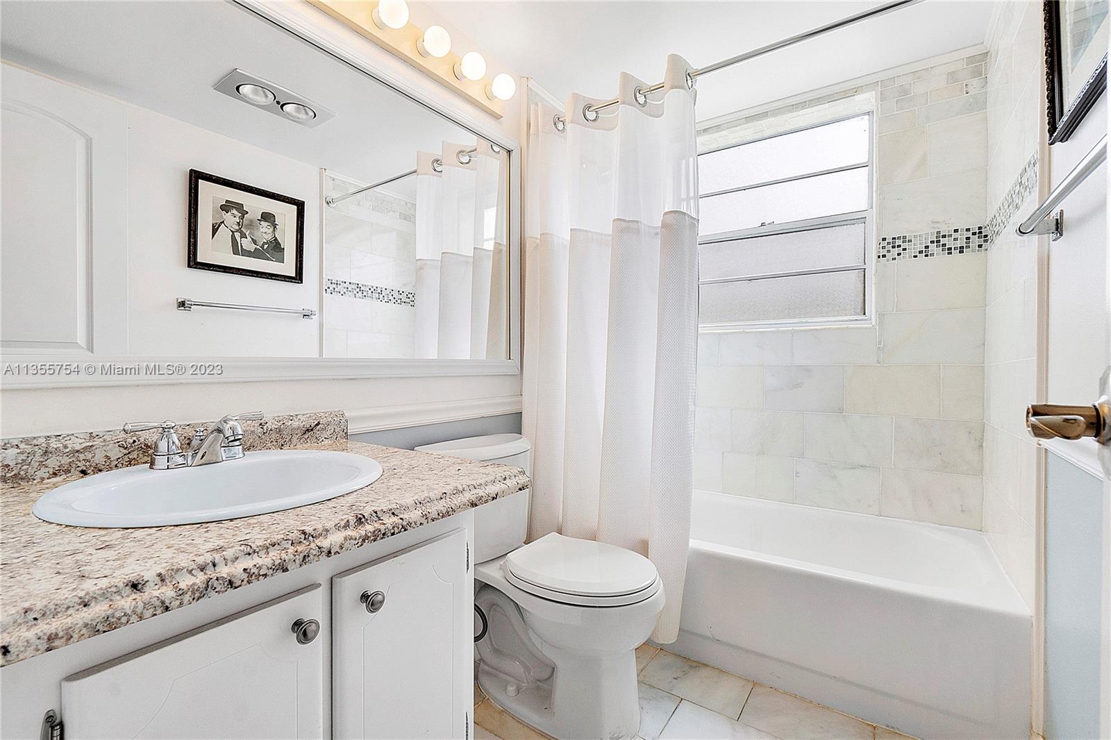 357 Durham, Unit 357 Deerfield Beach, FL 33442 - Photo 9 of 41 a bathroom with a granite countertop sink toilet and shower