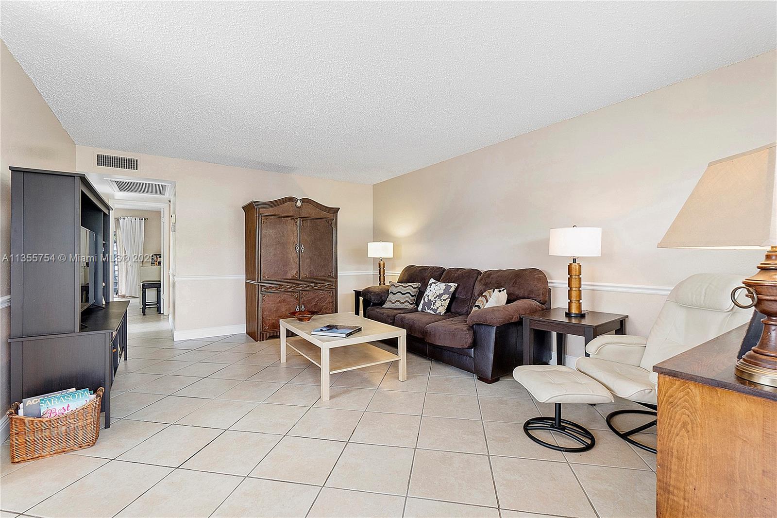 357 Durham, Unit 357 Deerfield Beach, FL 33442 - Photo 10 of 41 a living room with furniture and a table
