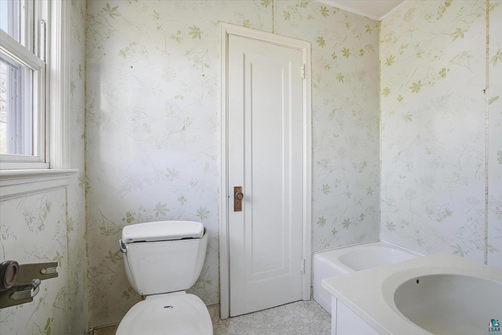 709 Michigan Street Hibbing, MN 55746 - Photo 12 of 47 Full bathroom with a garden tub, vanity, and wallpapered walls