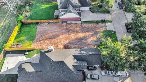 an aerial view of a house with yard