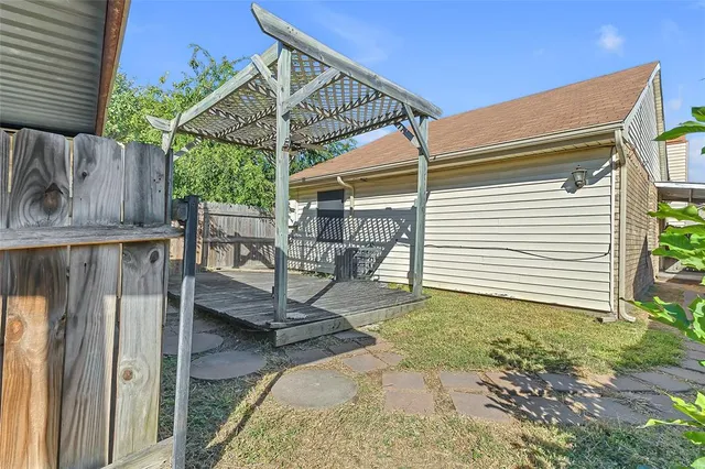 a view of a patio with table and chairs potted plants with wooden floor