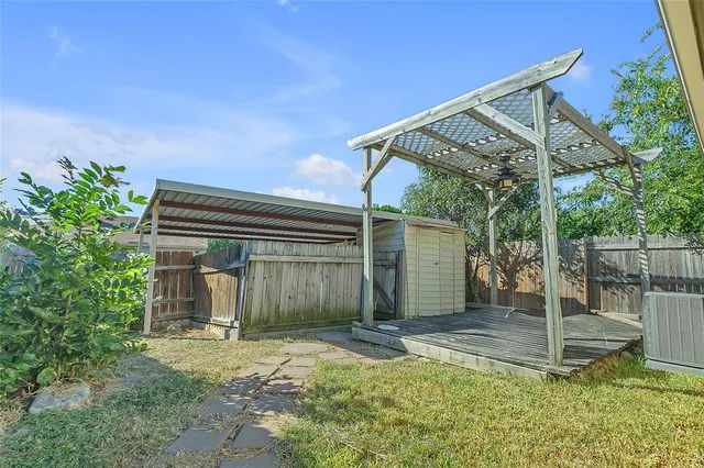 a backyard of a house with table and chairs